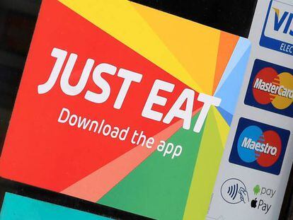 FILE PHOTO: Signage for Just Eat is seen on the window of a restaurant in London, Britain, August 5, 2019. REUTERS/Toby Melville/File Photo