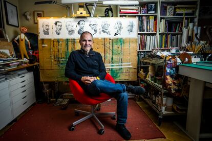 The painter and illustrator Fernando Vicente poses in his studio, in Madrid, with his latest caricatures of writers.