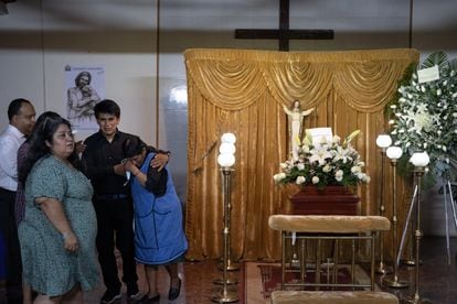 Juan Jose Florez and Leonarda Valverde attend the wake of their brother and son, Rosalino Florez, who died after receiving 36 pellets from the National Police of Peru.