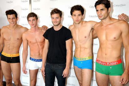 The model who didn't want to be: Jamie Dornan surrounded by Calvin Klein brand award hopefuls in an Oxford Street store in London in September 2009.