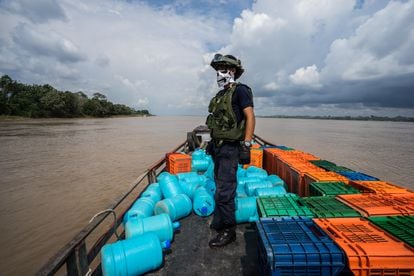 A policeman from the Peruvian coast guard patrols the Amazon area. 
