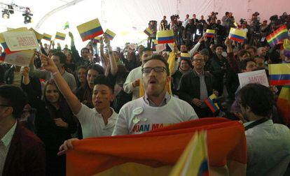 Colombianos simpatizantes de Juan Manuel Santos reaccionan tras conocer los primeros resultados.