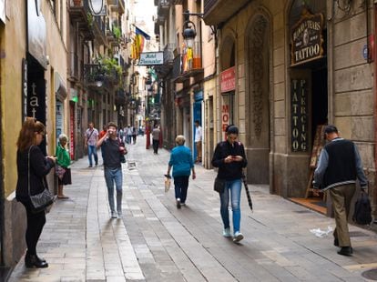 People walking down a shopping street in Barcelona.