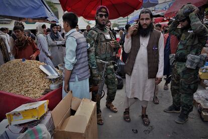 El comandante talibán Mohamed Muslim, de 35 años, pasea protegido por algunos de sus hombres por un mercado de Kabul.