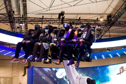 Visitors, wearing mandatory FFP2 masks, experience SK Telecom's Metaverse 4D at Mobile World Congress 2022 in Barcelona.