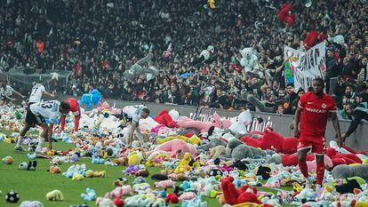 Fans throw toys onto the pitch during the Turkish Super League soccer match between Besiktas and Antalyaspor at the Vodafone stadium in Istanbul, Turkey, Sunday, Feb. 26, 2023. During the match, supporters threw a massive number of soft toys to be donated to children affected by the powerful earthquake on Feb. 6 on southeast Turkey. (AP Photo)