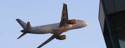A Vueling Airbus A320 aircraft flies at Barcelona's airport