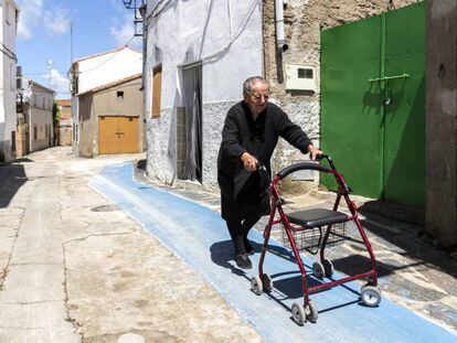 Tía Rosa, de 86 años, camina con el andador por el carril habilitado para ello.