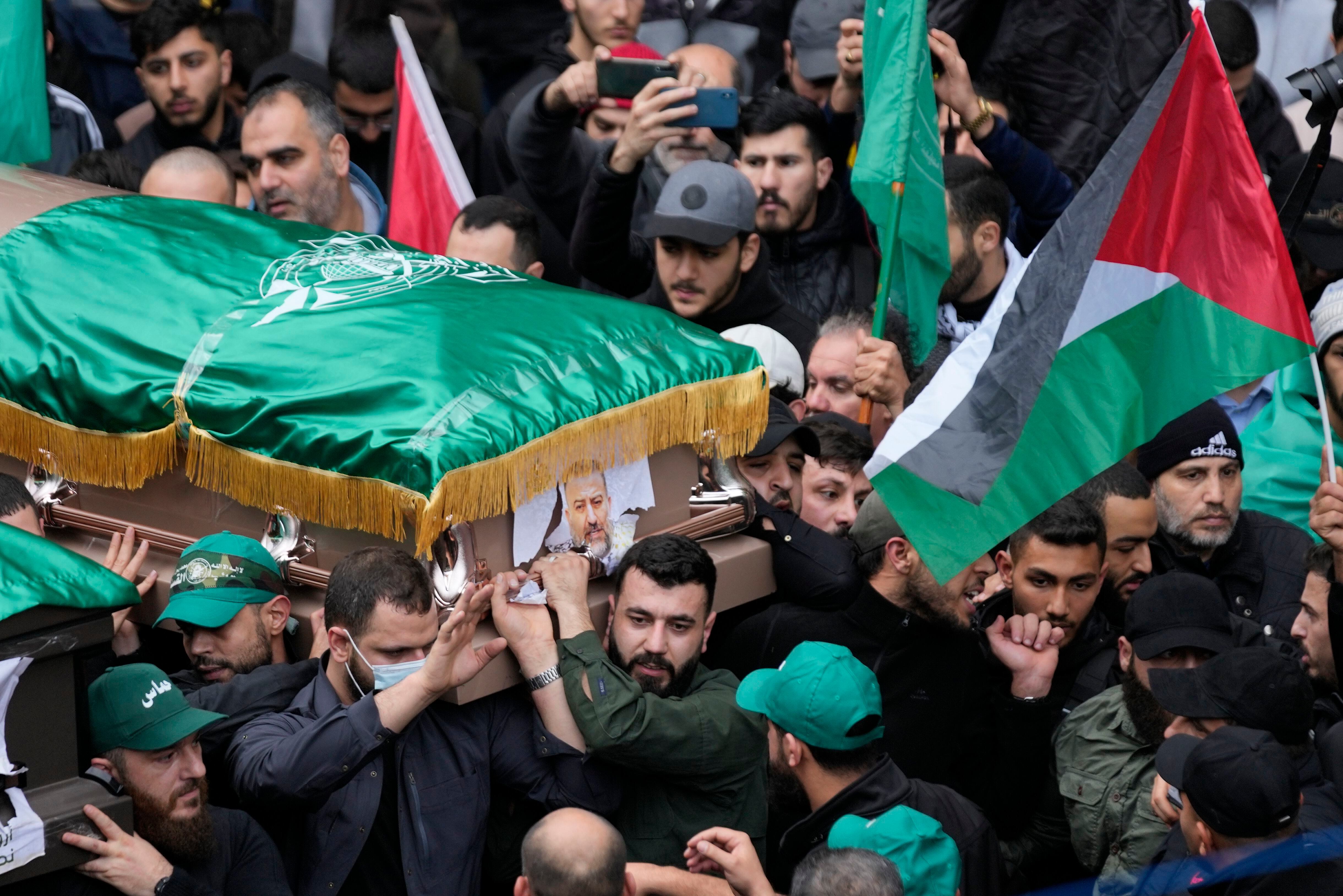 Mourners carry the coffin of Saleh Arouri, one of the top Hamas commanders, who was killed in an apparent Israeli strike Tuesday, during his funeral in Beirut, Lebanon, Thursday, Jan. 4, 2024. (AP Photo/Hussein Malla)