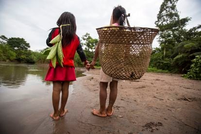 Two girls of the Waorani ethnic group, along the Amazon River in Ecuador.