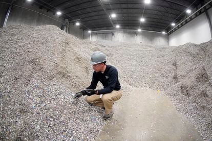A member of the Alterra Energy company works at the shredded plastics storage area in Akron, Ohio, in 2022. 