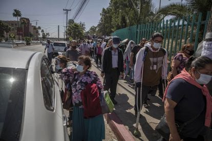Dozens of people wait in line to be vaccinated against covid-19 in Tijuana, Baja California, on June 12.