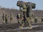 A Ukrainian serviceman carries an NLAW anti-tank weapon during an exercise in the Joint Forces Operation, in the Donetsk region, eastern Ukraine, Tuesday, Feb. 15, 2022. While the U.S. warns that Russia could invade Ukraine any day, the drumbeat of war is all but unheard in Moscow, where pundits and ordinary people alike don't expect President Vladimir Putin to launch an attack on its ex-Soviet neighbor. (AP Photo/Vadim Ghirda)