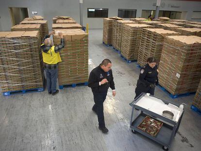 Agentes aduaneros y tributarios de EE UU examinan un cargamento de fresas en Tijuana