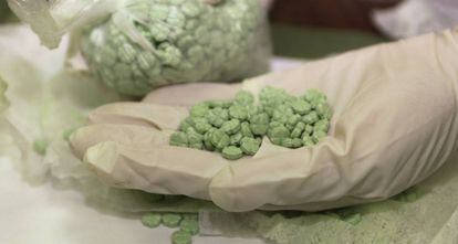 Un policía estadounidense muestra pastillas de droga en Los Ángeles.