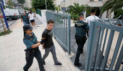 La Guardia Civil entra con los detenidos a su apartamento para un registro.