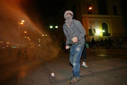 Un joven lanza piedras a los policías en los disturbios del paro nacional de 48 horas convocado en Chile