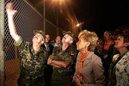 La vicepresidenta escucha, de madrugada, las explicaciones de un oficial en la valla fronteriza de Melilla.