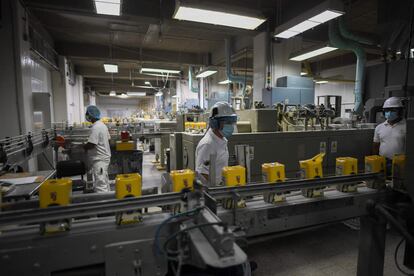 Polar workers check boxes of corn flour at the Turmero plant.