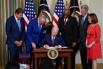 El presidente de Estados Unidos, Joe Biden, firma la ley de Reducción de la Inflación, este martes en la Casa Blanca, rodeado de algunos congresistas demócratas.