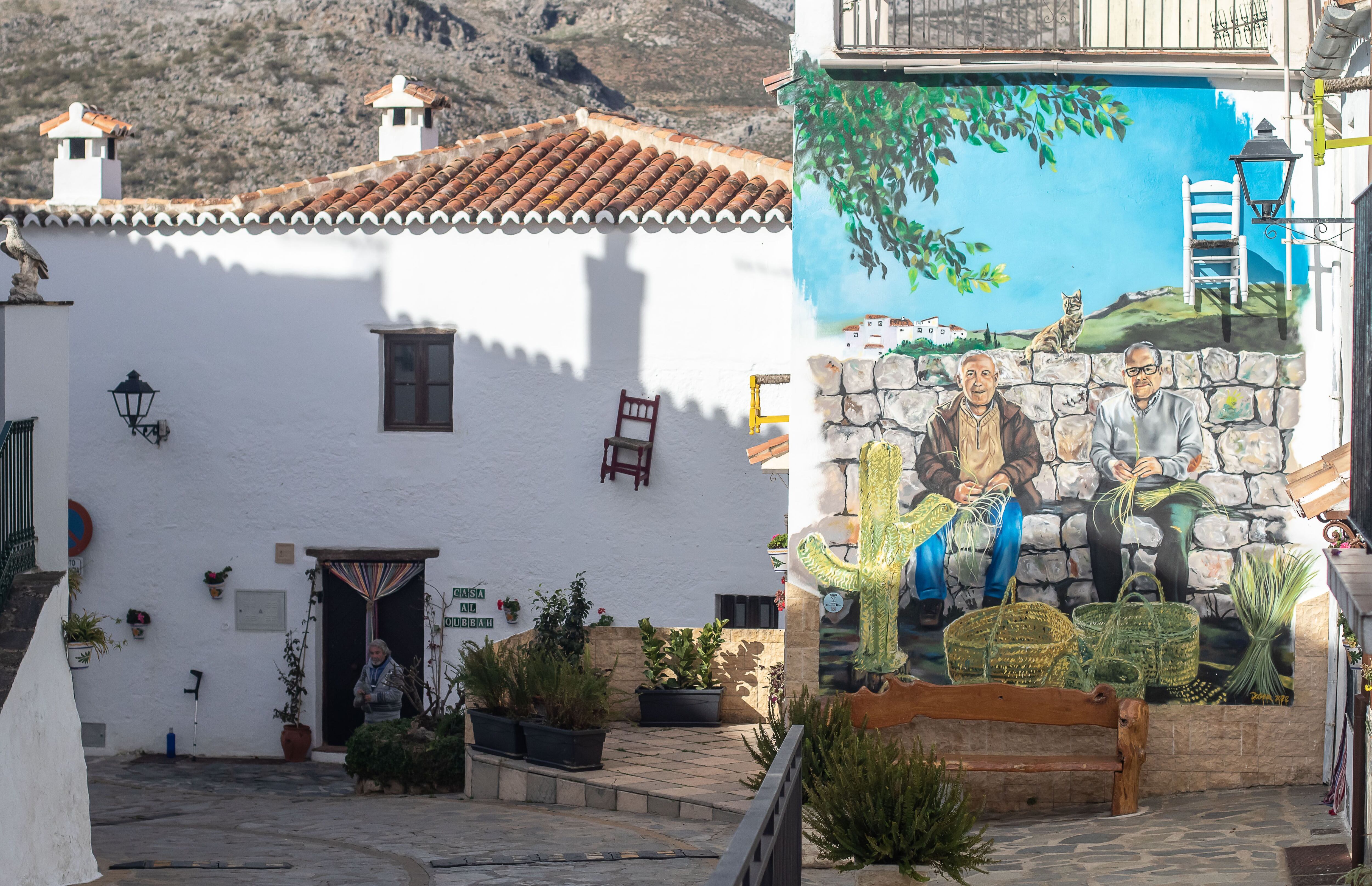 Mural dedicado a Mateo Peña y Vicente Sánchez en una de las calles de Parauta, en la que también se observan las sillas que decoran las vías de la localidad.