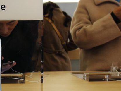 Un joven probando un modelo de iPhone en una tienda de Apple en Pek&iacute;n. 