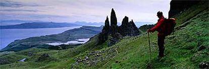 Excursionista mirando el paisaje húmedo de la isla de Skye, la mayor de las islas Hébridas interiores (el conjunto del archipiélago, al oeste de Escocia, está formado por medio millar de islas).