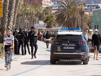 Un vehículo de la Policía Nacional junto a varios agentes en el paseo marítimo Pablo Ruiz Picasso de Málaga, el pasado mes de marzo.