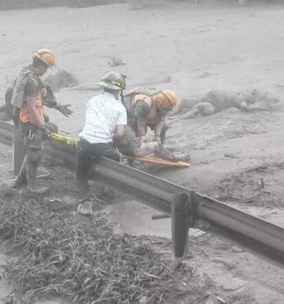 Trabajos de rescate bajo la lluvia de ceniza en Guatemala, este domingo.