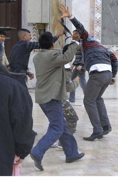Partidarios del régimen sirio golpean a manifestantes en la mezquita de los Omeyas de Damasco, ayer tras el rezo.