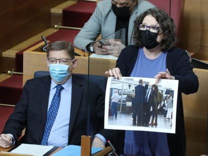La vicepresidenta de la Generalitat, Mónica Oltra, muestra una imagen de Francisco Camps (de espaldas), con Alberto de Rosa (Ribera Salud) y Cristina Seguí, en las Cortes valencianas.