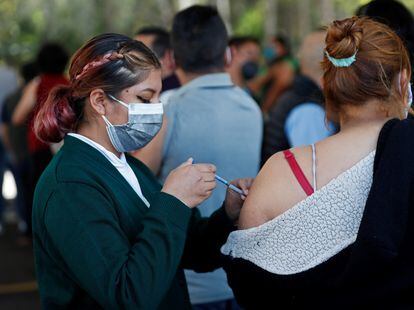 Una enfermera vacuna a una maestra contra la covid-19 en México
