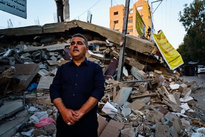Bookseller and publisher Samir Mansour stands in front of the remains of his bookstore, destroyed by an Israeli bombardment, in May in Gaza.