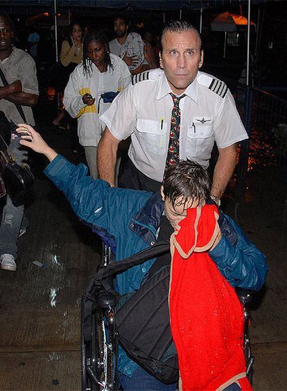 Uno de los pasajeros heridos llora tras el accidente en el aeropuerto de Kingston, Jamaica.