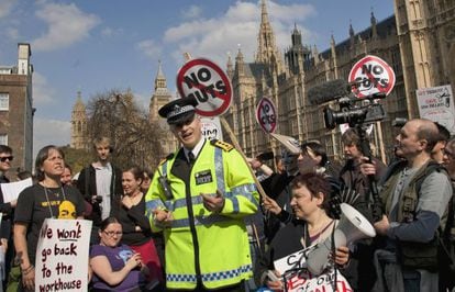 Un policía trata de dispersar una concentración ante el Parlamento en contra de los recortes.