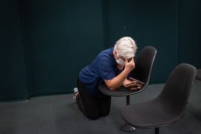 A woman kneels during the evangelical worship held in a room of the Chamber of Deputies, on June 13.