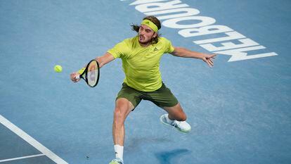 Greece's Stefanos Tsitsipas hits a backhand return to Spain's Rafael Nadal during their quarterfinal match at the Australian Open tennis championship in Melbourne, Australia, Wednesday, Feb. 17, 2021.(AP Photo/Andy Brownbill)