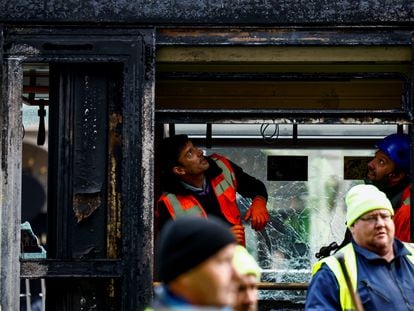 Trabajadores inspeccionan uno de los vagones de tranvía incendiados durante los disturbios violentos de este jueves en Dublín