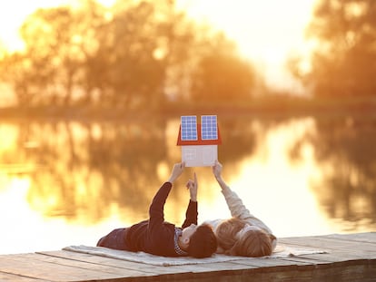 Happy couple of children dreaming of a house with solar panels