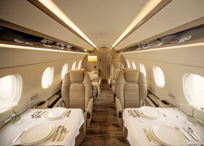 Interior of the cabin of a G650 jet, with dining room service.