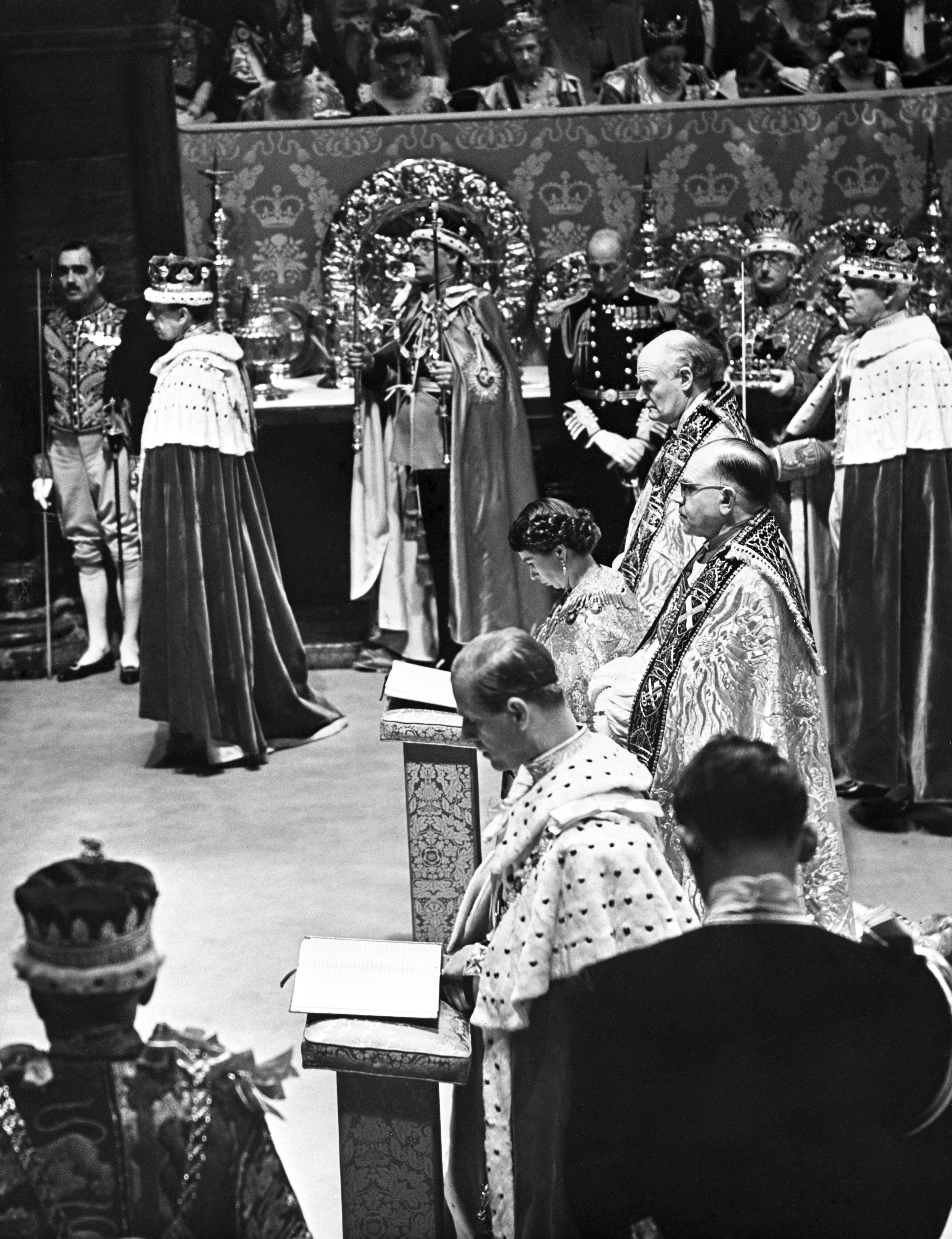La reina y su marido, el duque de Edimburgo, arrodillados uno al lado del otro frente al altar para recibir la comunión en la abadía de Westminster, después de las ceremonias de coronación y homenaje.