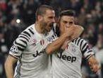 Juventus' Paulo Dybala celebrates scoring their first goal with Leonardo Bonucci