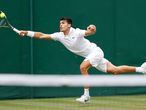 Spain's Carlos Alcaraz returns to Japan's Yasutaka Uchiyama during their men's singles first round match on the third day of the 2021 Wimbledon Championships at The All England Tennis Club in Wimbledon, southwest London, on June 30, 2021. (Photo by Adrian DENNIS / AFP) / RESTRICTED TO EDITORIAL USE
