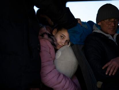 Alesiy, 10, looks out of a bus at the city of Bashtanka, after she and her family escape from the Kherson district, Ukraine on Thursday, April 7, 2022. (AP Photo/Petros Giannakouris)