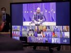 European Council President Charles Michel, top, and European leaders are shown on screen during a EU summit video conference at the European Council headquarters in Brussels, Thursday, Jan. 21, 2021. Worried that the new coronavirus variants could result in another surge of deaths across the European Union and push hospitals to the verge of collapse, EU leaders will assess in a video summit Thursday such measures as further border restrictions, better tracking of mutations and improving coordination of lockdowns. (Oliver Hoslet, Pool Photo via AP)