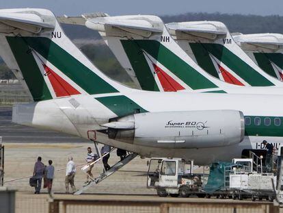 Pasajeros bajando de un avión de Alitalia.