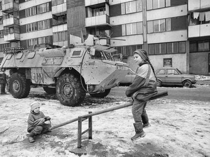 Dos niños juegan durante el cerco de Sarajevo ante un blindado de Naciones Unidas, imagen incluida en el documental de Movistar ‘Gervasio Sánchez. Álbum de posguerra’.