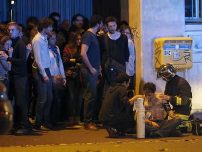 Un bombero atiende a un hombre herido cerca de la sala Bataclan, tras los atentados yihadistas en París en 2015.