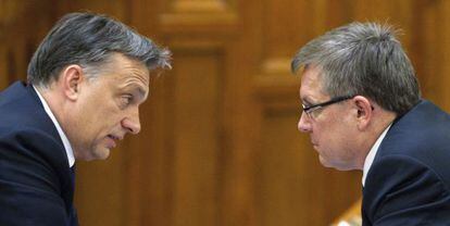 El primer minsitro h&uacute;ngaro Viktor Orban (i) habla con el ministro de Econom&iacute;a Gyorgy Matolcsy (d), en el parlamento de Budapest, Hungr&iacute;a, el d&iacute;a 23 de diciembre de 2011.