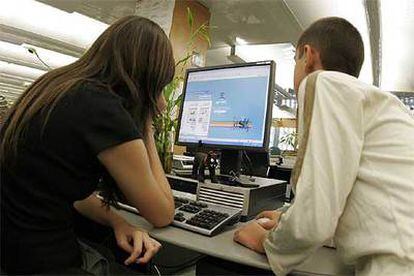 Dos jóvenes estudiantes  acceden a  Internet.